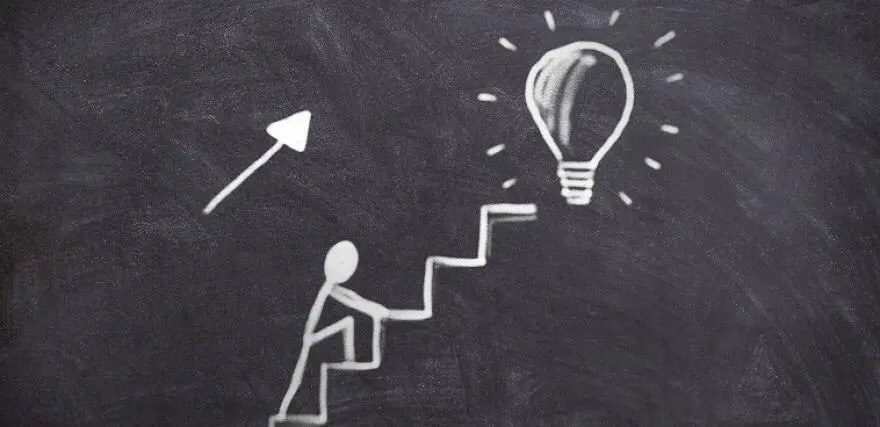 Agile-is-great-but Chalkboard drawing of stick figure walking up stairs toward a lightbulb